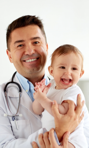 pediatrician holding baby on a clinic